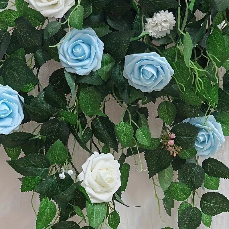 A lush green garland featuring light blue and white artificial roses and foliage for DIY decor.