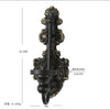 Vintage black wall-mounted double candle holder with ornate scrollwork and a hanging loop