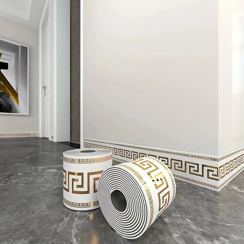 Roll of self-adhesive PVC baseboard trim featuring a white and gold brick pattern on a gray floor.