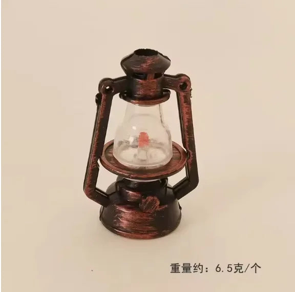 A vintage ceramic miniature lantern with a glass bulb and metal frame for dollhouse décor.
