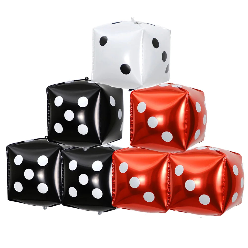 A collection of black and orange casino dice foil balloons stacked together.
