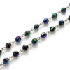 A strand of vintage cross and Virgin Mary pendant rosary necklace featuring iridescent, multi-colored gemstone beads.