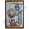 A vintage metal sign featuring a rustic teapot and floral elements, with the word WELCOME written vertically.