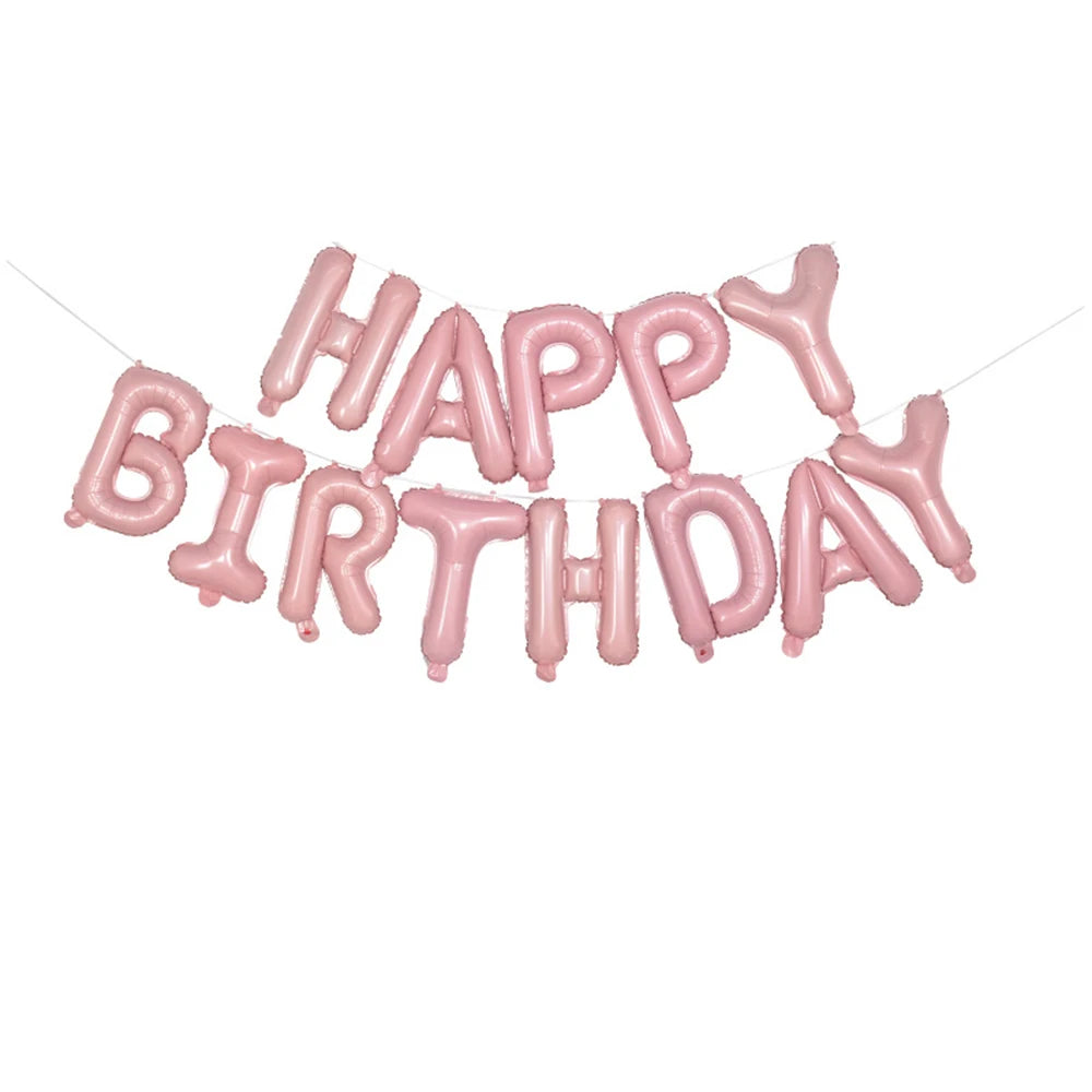 A string of pink foil letter balloons spelling out HAPPY BIRTHDAY for birthday decoration