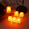 A set of six battery-powered LED Halloween candles with flickering flames arranged on a wooden box.