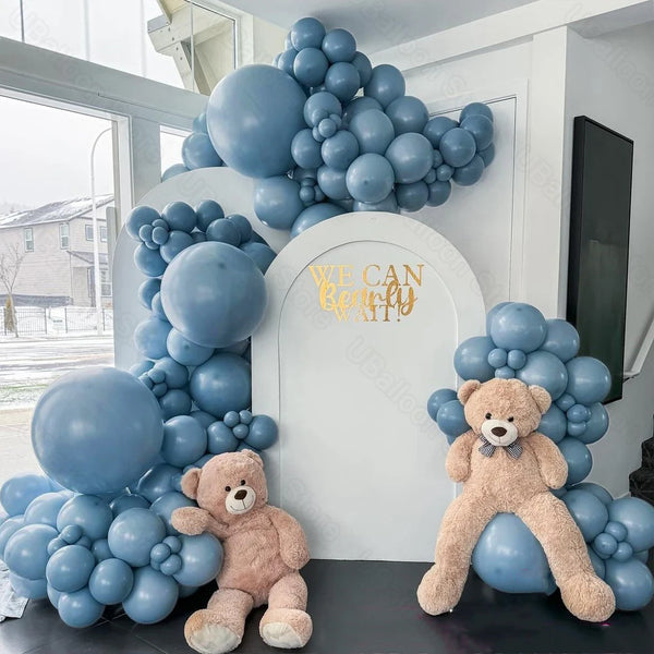 A dusty blue balloon garland featuring teddy bears and balloons for parties and celebrations.