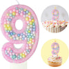 Pink macaron number birthday candles set showing the number 9 in various colors and cupcake forms