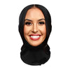 A woman with dark hair and makeup smiling directly at the camera wearing a realistic full-face cosplay mask.