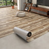Roll of 3D textured wood grain self-adhesive flooring film on a light gray floor.