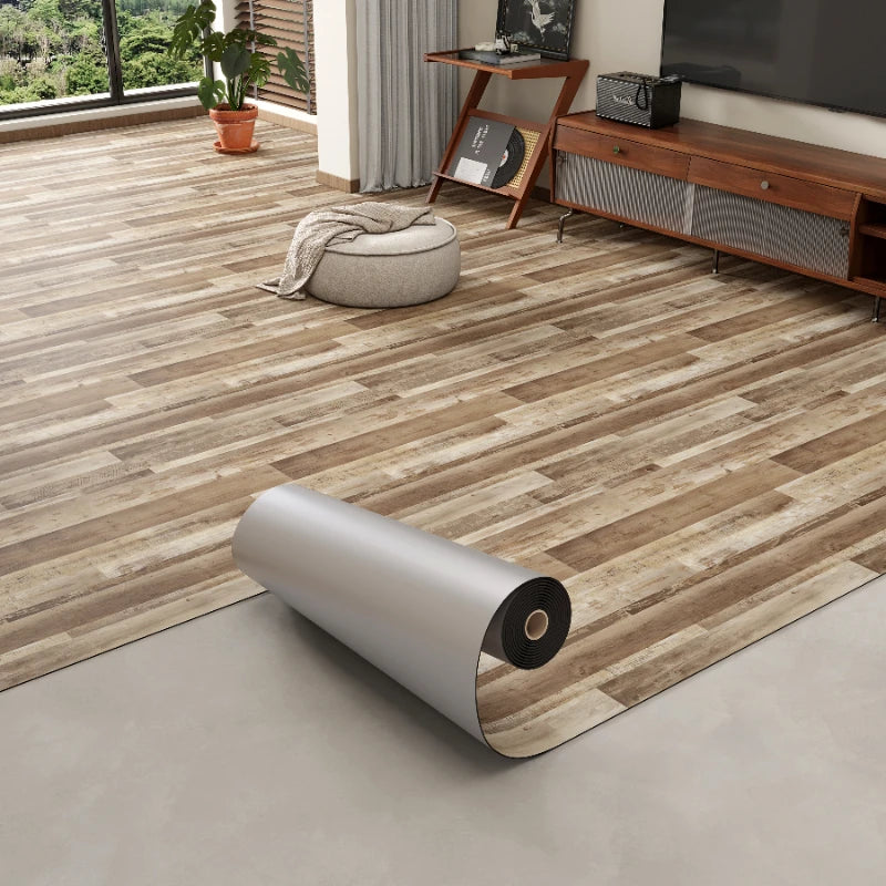 Roll of 3D textured wood grain self-adhesive flooring film on a light gray floor.