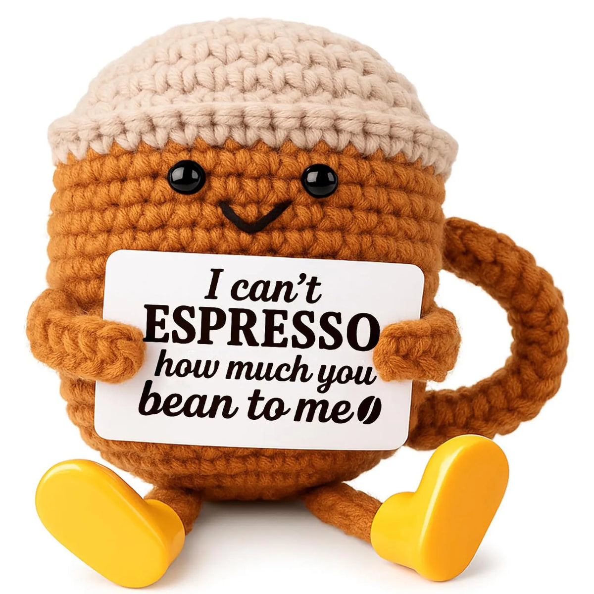 A handmade crochet donkey ornament with a smiling face holding a sign that reads I can't espresso how much you bean to me