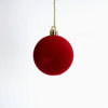 A single deep red velvet flocked Christmas tree ornament hanging by a gold loop.