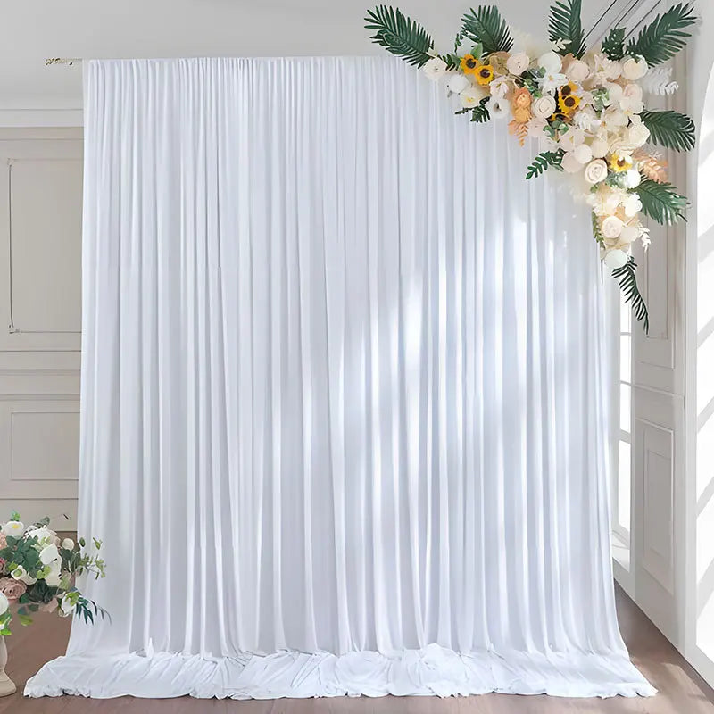 Elegant white rectangular backdrop drapes with floral greenery and white flowers for events