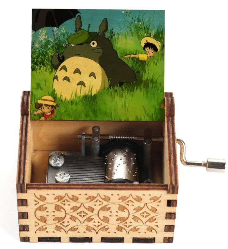 Hand-cranked wooden music box featuring a Totoro design set in a grassy landscape.