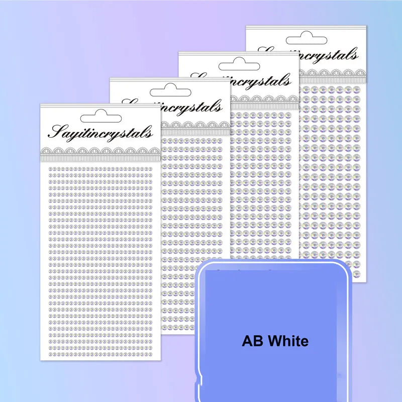 A stack of clear rhinestone embellishment packs in various sizes and colors, including an AB White option.