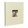 A beige linen front scrapbook memory book with a photo of a family.