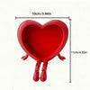 Red heart-shaped ornament with small legs, measuring 10cm long.