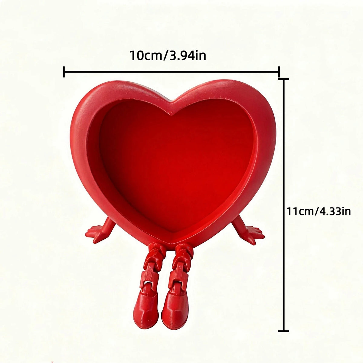 Red heart-shaped ornament with small legs, measuring 10cm long.