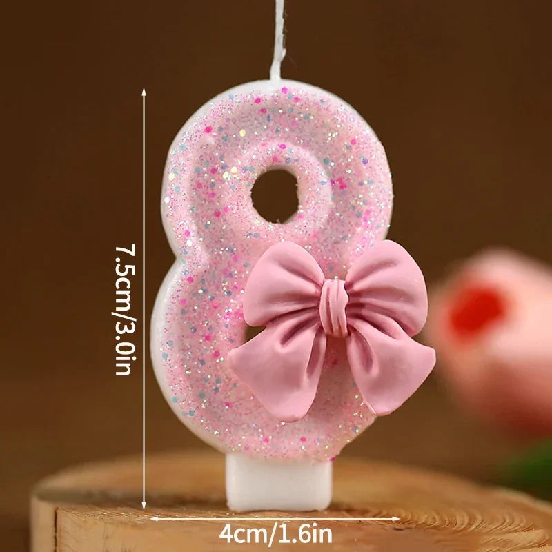 Set of number 8 cake topper candles in pink glitter with a pink bow
