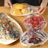 Reusable food storage bags filled with fresh red tomatoes and purple grapes