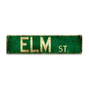 A rectangular, distressed green metal sign with gold lettering that reads ELM ST.