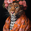 A portrait of a leopard with a floral crown and an orange patterned scarf against a dark background.