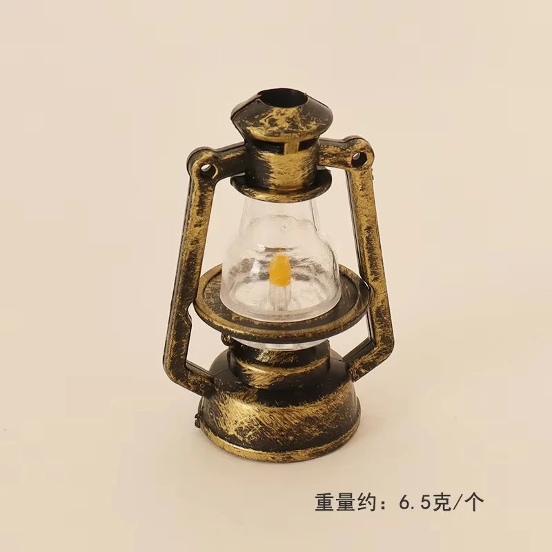 A vintage ceramic miniature lantern with a brass frame and a clear glass bulb, used for dollhouse décor.