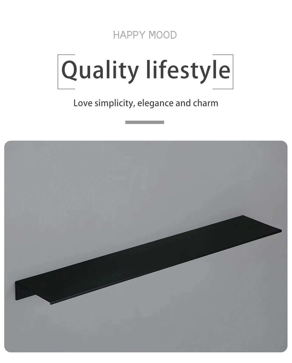 A sleek, modern matte black wall shelf or tray shown lying flat on a light gray surface.