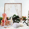 Elegant paper hand fans displayed with gift bags and thank you cards on a white table.