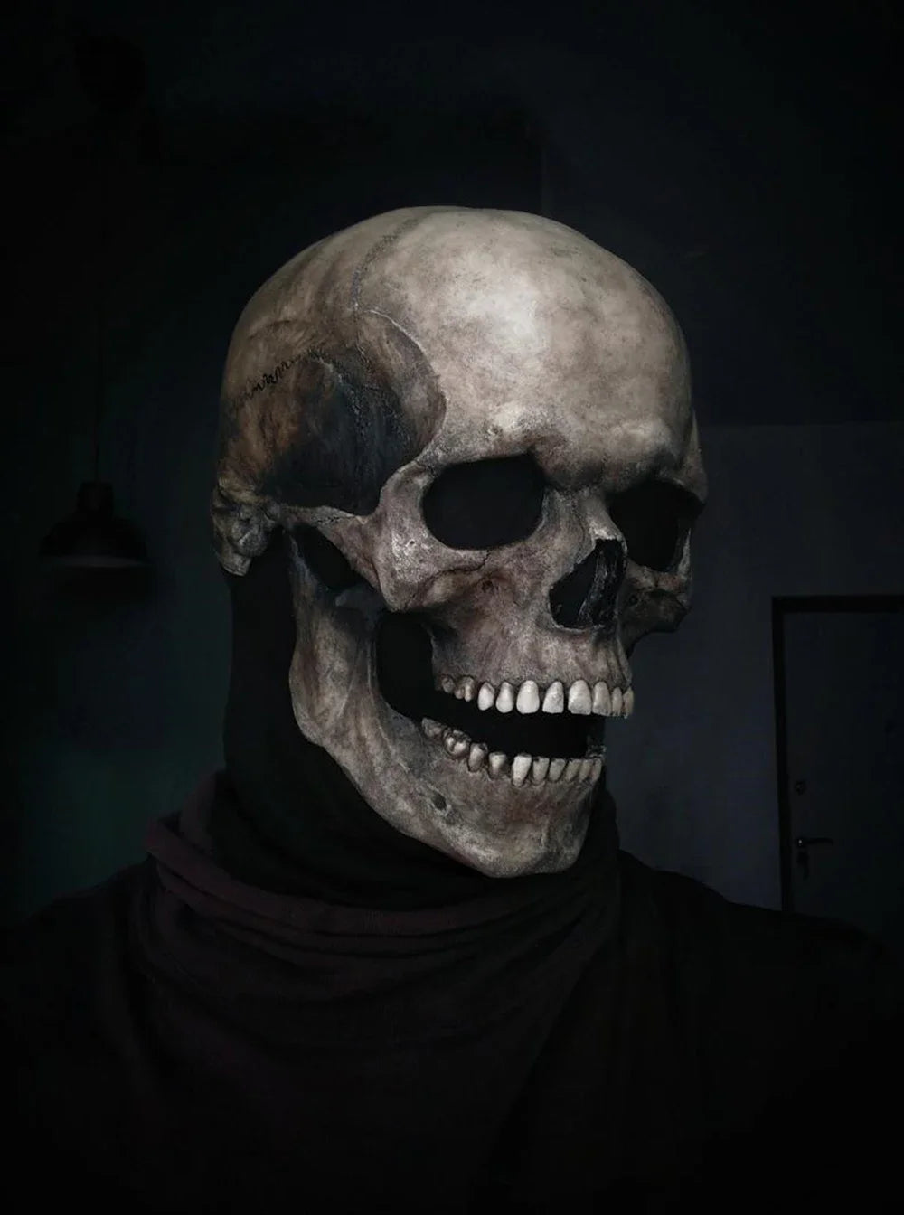 A realistic full head latex skull cosplay mask displayed against a dark background.