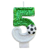 A custom number birthday candle shaped like the number 5, covered in green glitter, with a soccer ball detail on the bottom.