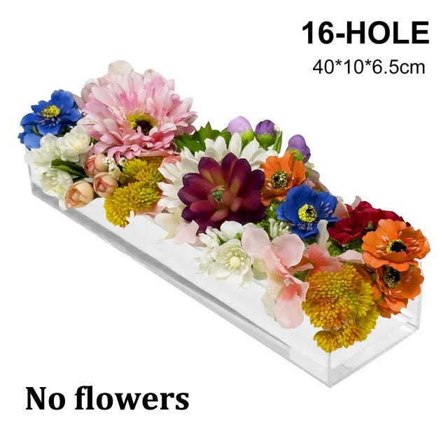 A 16-hole acrylic rectangular vase filled with a colorful arrangement of artificial flowers.
