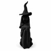A black witch figurine with a pointed hat and flowing robes.