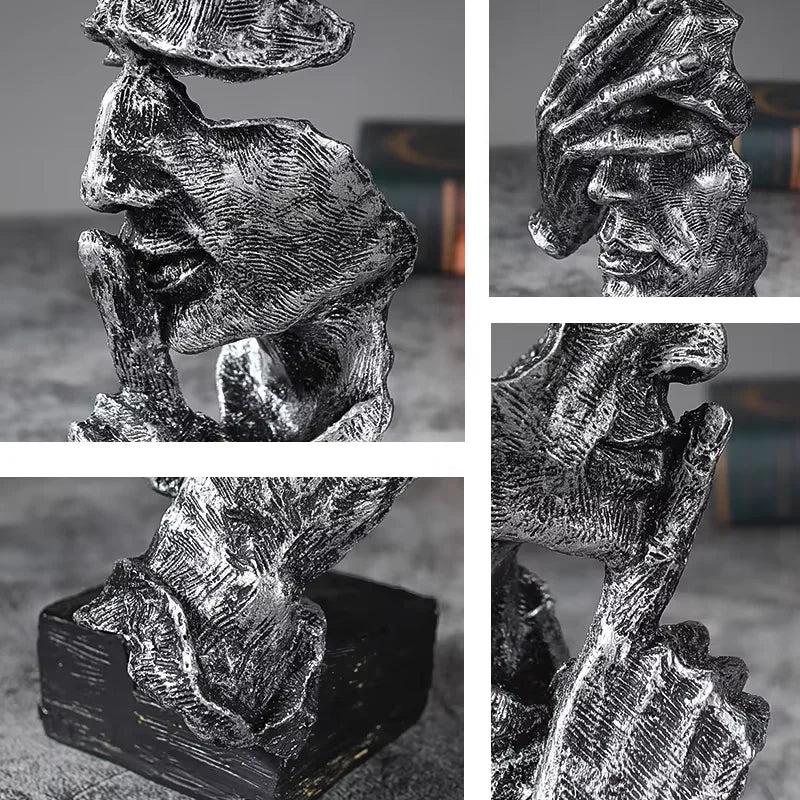 A set of three resin figurines depicting hands and faces, rendered in a textured, monochromatic style.