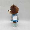 A brown bear plush toy with a blue collar and gray and white clothing, standing against a light background.