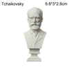 A white plaster bust miniature of Tschaikovsky with a beard and formal attire.