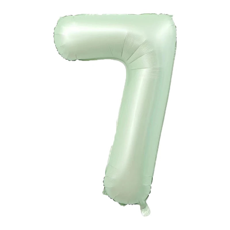 A light green foil number balloon shaped like the numeral 7.