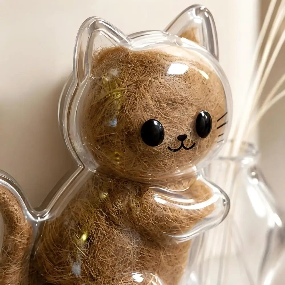 A clear capsule cat keepsake magnet made of brown fiber resembling a kitten.