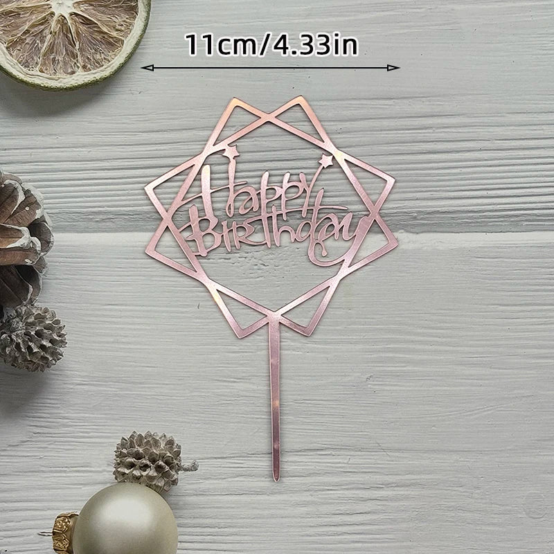 A pink acrylic cake topper set shaped like a geometric star with the words Happy Birthday