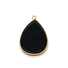 A black teardrop-shaped pendant charm with a gold-colored bail.