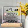 A clear acrylic desk sign with engraved text 'To My Daughter I Love You' and floral accents on a wooden base.