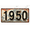A vintage aluminum license plate tag with the year 1950 embossed on it, showing signs of rust and wear.