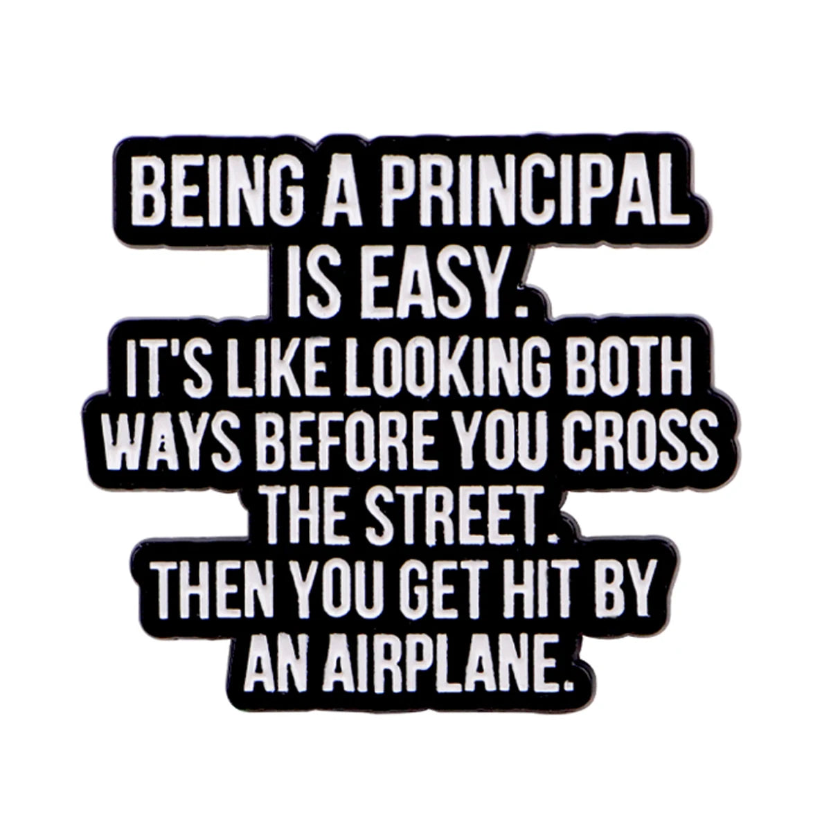 Black enamel pin with white text that reads Being a principal is easy. It's like looking both ways before you cross the stree
