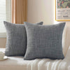 A set of two solid gray linen pillows resting on a white textured surface.