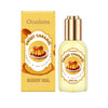 A bottle of Oceaura Sweet Caramel body oil with a gold label and packaging box.