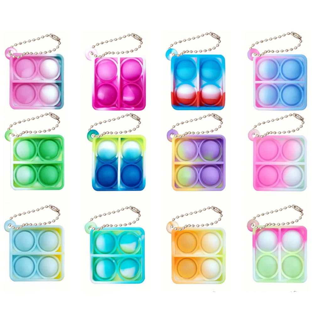 A collection of colorful mini sensory fidget keychains in various shades of pink, blue, green, and yellow.