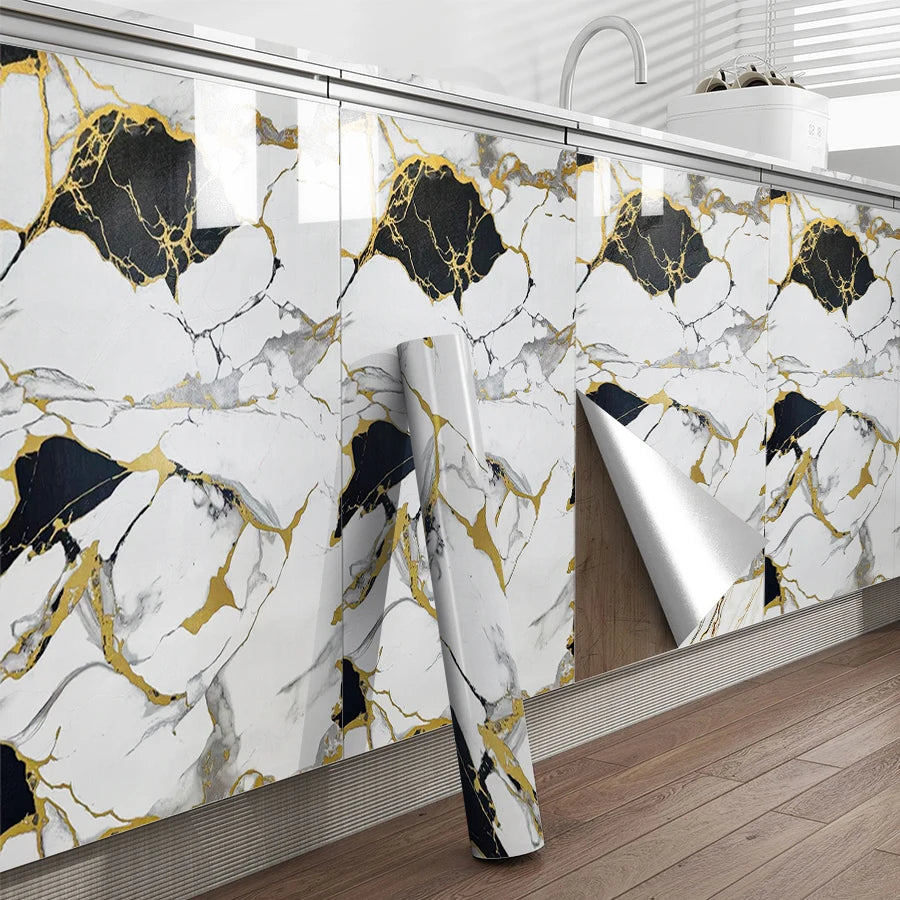 A kitchen wall featuring marble-patterned tiles with gold veining and black accents.