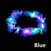 Blue LED flower crown headband with glowing lights against a black background