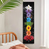 A vertical tapestry featuring a dark background with colorful flowers and a white orchid for boho spiritual decor.