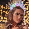 A woman wearing a luminous LED glowing crown or headband with iridescent light effects.